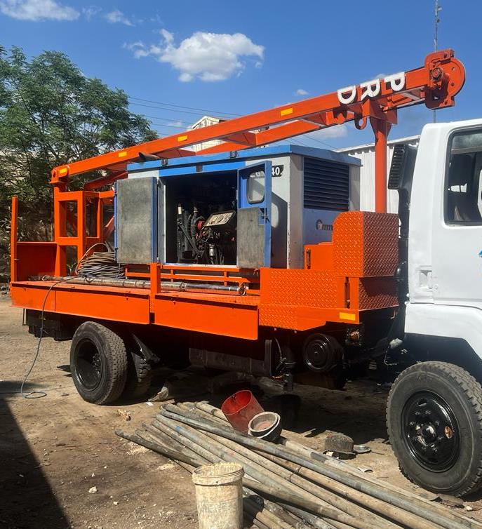 Borehole rehabilitation in Kiambu County, Kenya — Amroth service rig with drilling rods