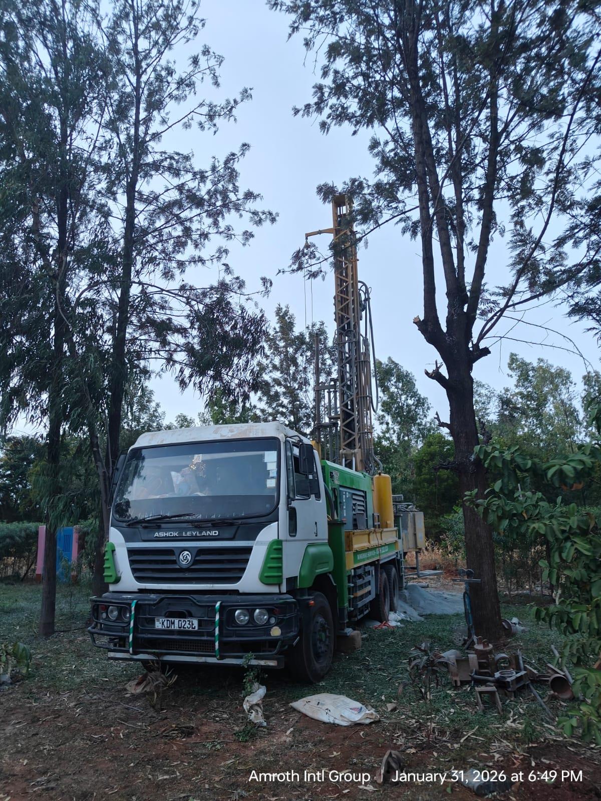 Borehole drilling in East Africa — Rig working on site at dusk