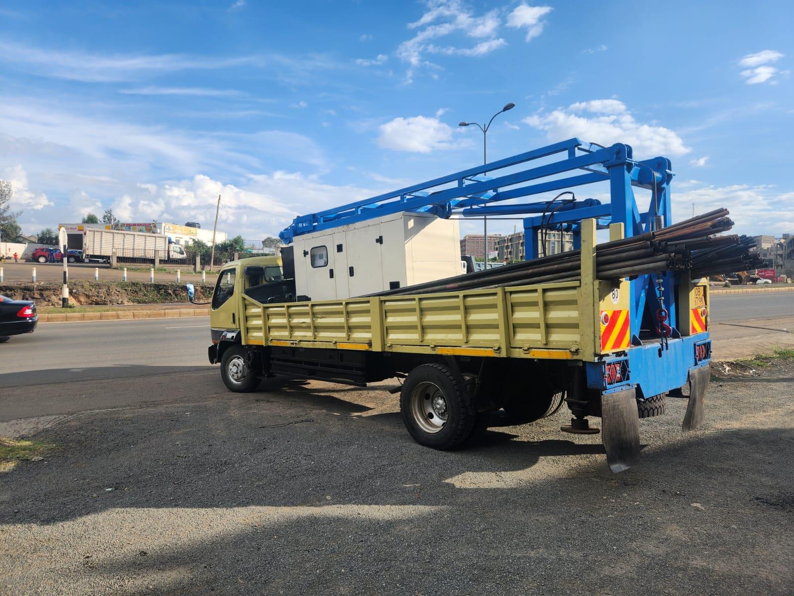 Cross-border rig mobilisation — Amroth borehole drilling rig truck loaded with drilling rods