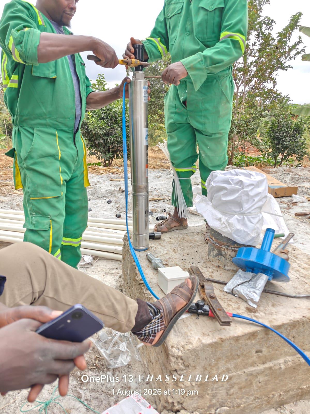 Borehole pump installation in Mlolongo, Kenya — Amroth technicians fitting a submersible pump at the wellhead